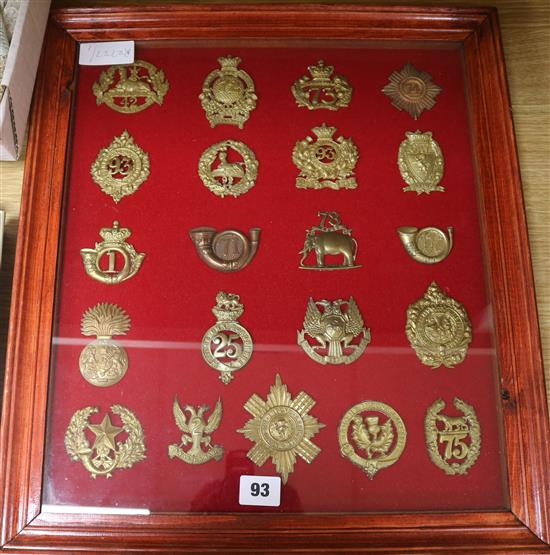 A framed collection of military badges